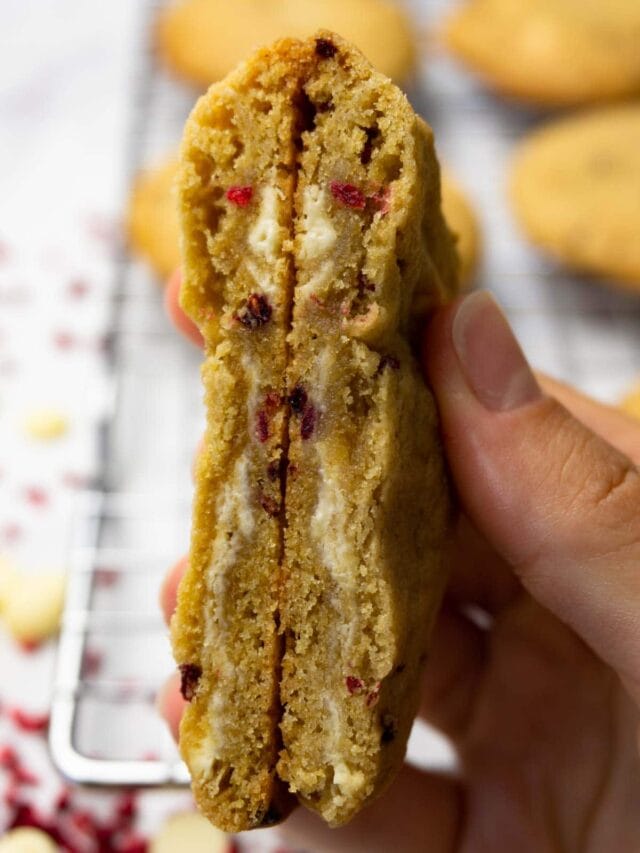 Cut in half cookie with white chocolate chips and freeze dried raspberries.