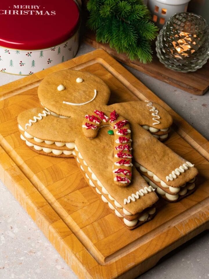 Gingerbread man cake on a wooden serving board.
