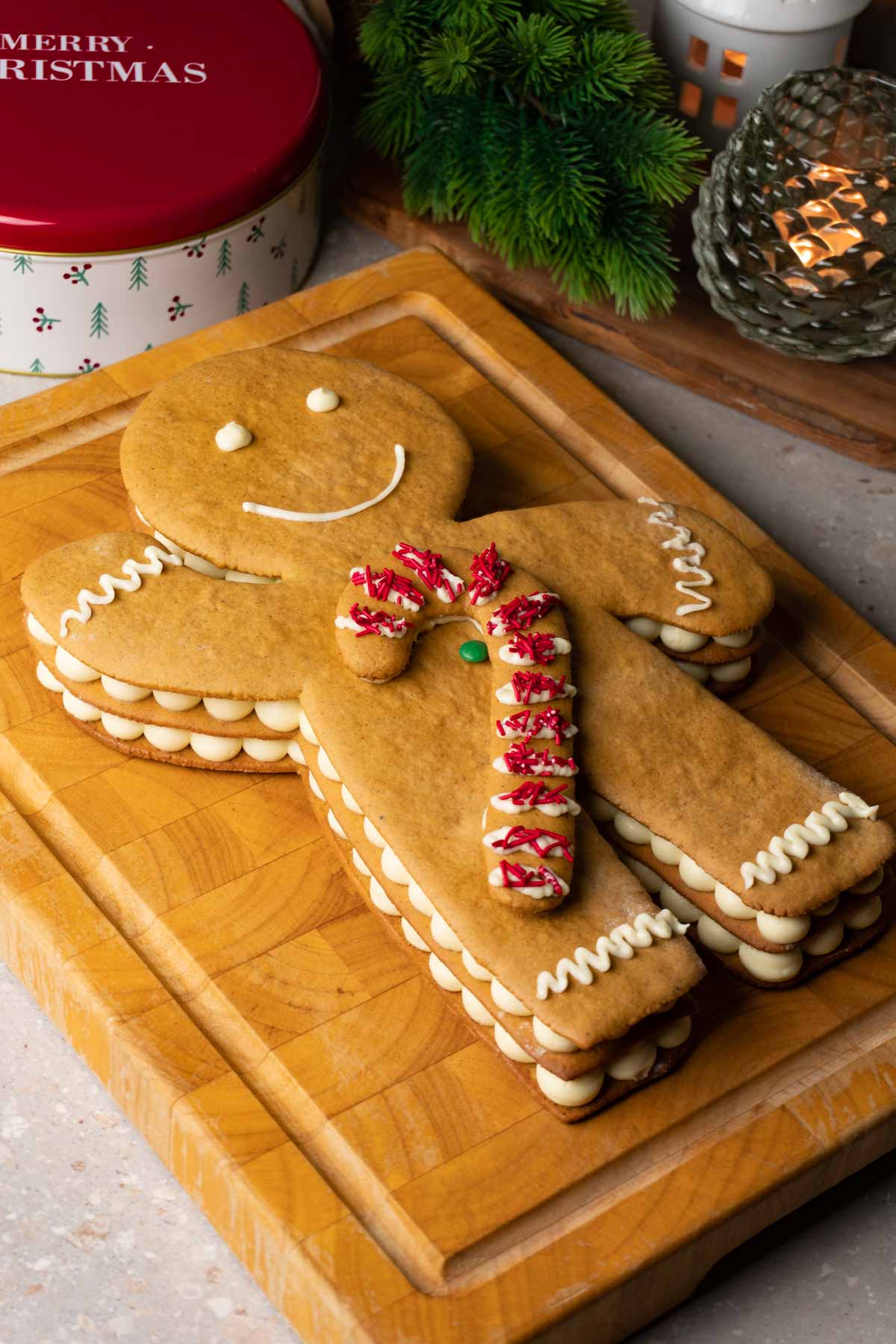 Gingerbread man cake on a wooden serving board.