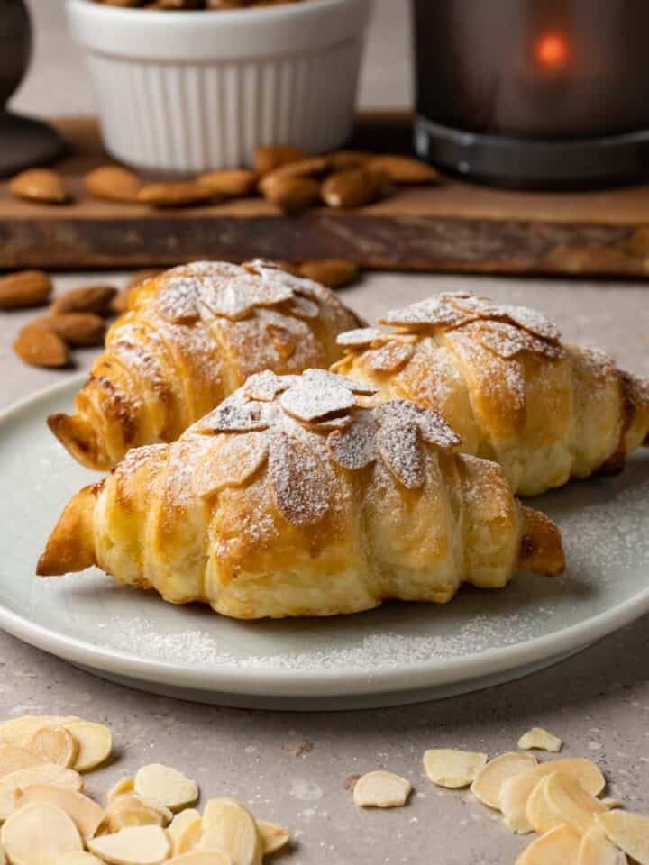 Croissants with almond filling, topped with sliced almonds and powdered sugar.
