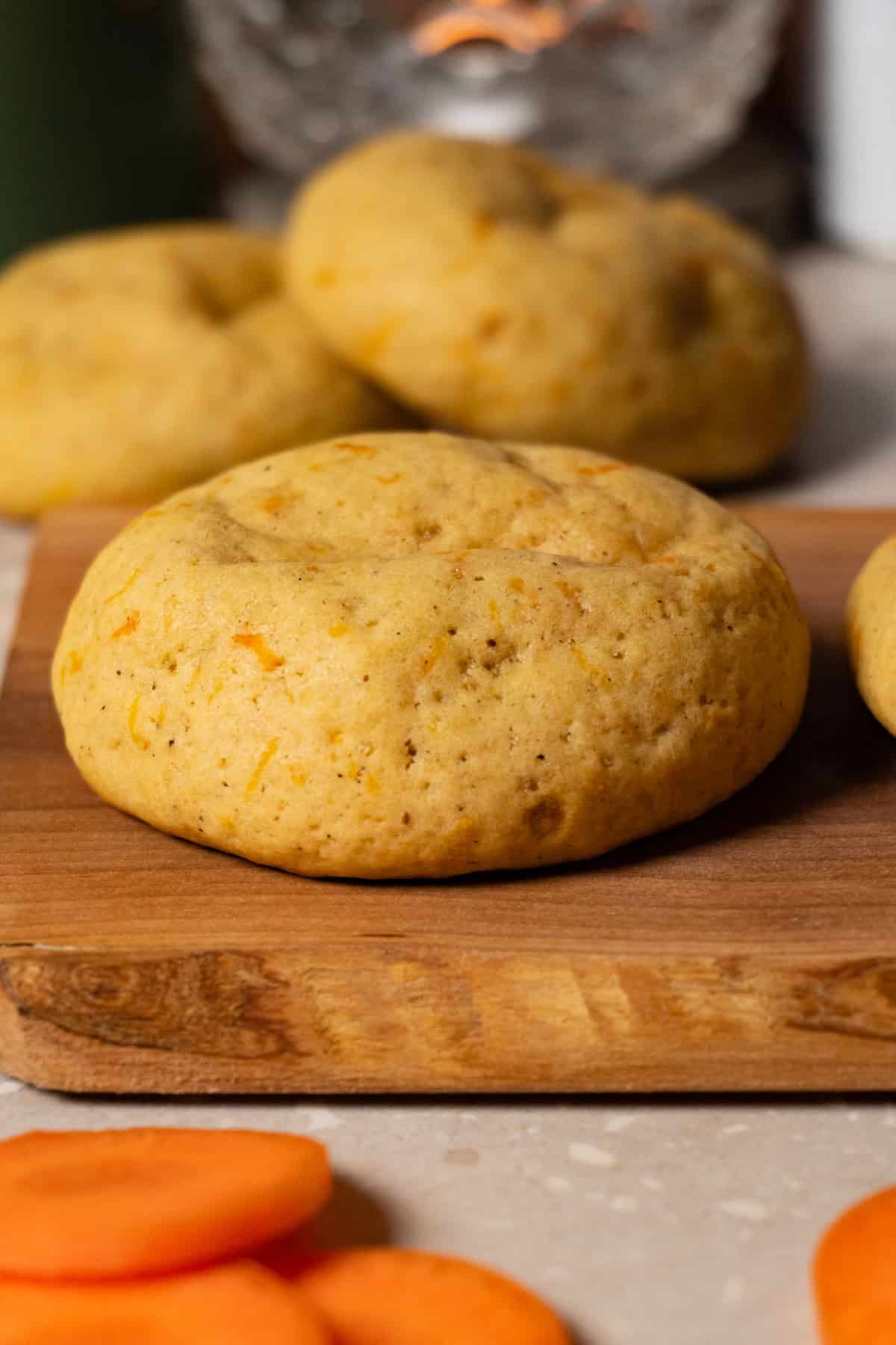 A cookie is lying on a wooden board.
